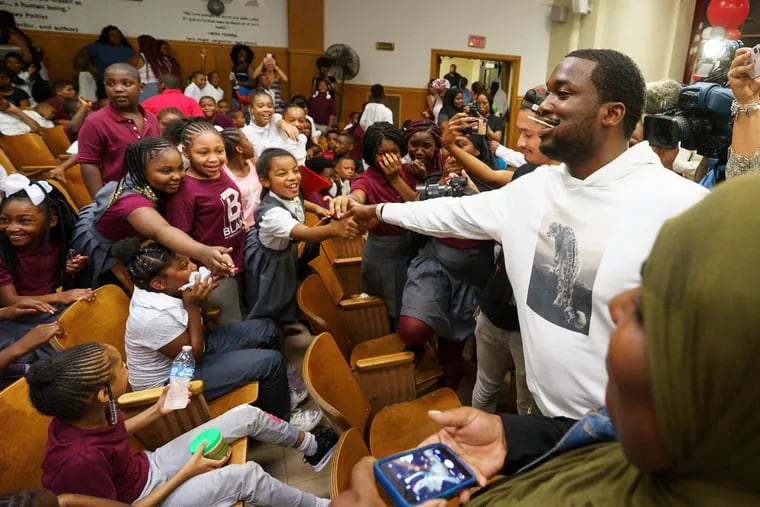 Rapper Meek Mill greets students at James G. Blaine Public School in Philadelphia, Wednesday, August 29, 2018. He donated backpacks with school supplies to students at this school.