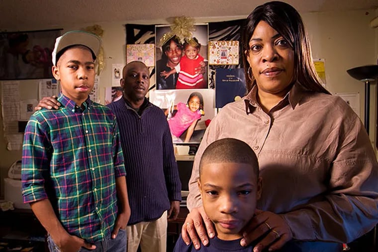 Janice Brown has been fighting to get her grandchildren back after placement by DHS. Her daughter died in a car accident that killed 4 in the Feltonville section of the city in 2009. In the picture are Janice Brown with grandson Kyshone Smith, 7, and in background are husband Maurice West and her son Dontay Gilliam, 14. ( ALEJANDRO A. ALVAREZ / STAFF PHOTOGRAPHER )