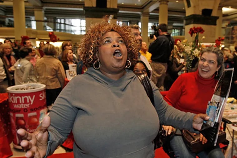 Sonie Berry of Southwest Philly sings with others at the Macy's Department Store in Center City. (Akira Suwa / Staff Photographer)