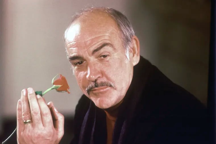 Sean Connery holds a rose in his hand as he talks about his new movie "The Name of the Rose" at a news conference in London.  Scottish actor Sean Connery, considered by many to have been the best James Bond, has died aged 90, according to an announcement from his family.