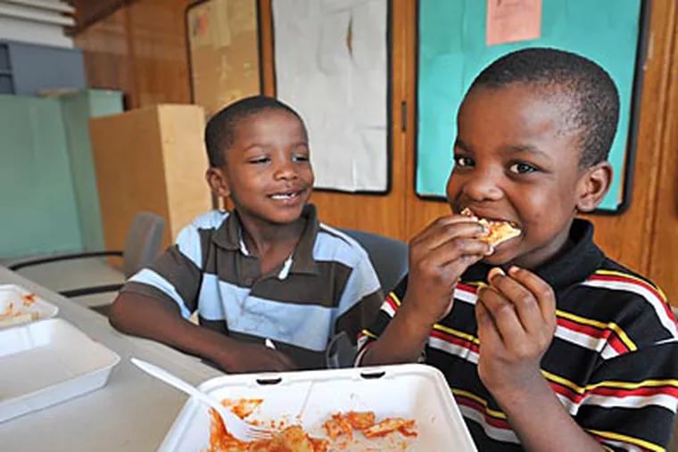 Jilani Schenck, 7, eats a lunch provided by the Phila. Housing Authority’s Summer Food Program. (SHARON GEKOSKI-KIMMEL / Staff)