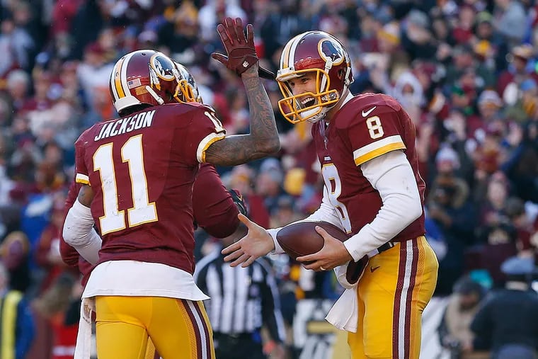 Washington Redskins quarterback Kirk Cousins (8) celebrates with Redskins wide receiver DeSean Jackson (11) after scoring a touchdown against the Buffalo Bills in the second quarter at FedEx Field. The Redskins won 35-25.