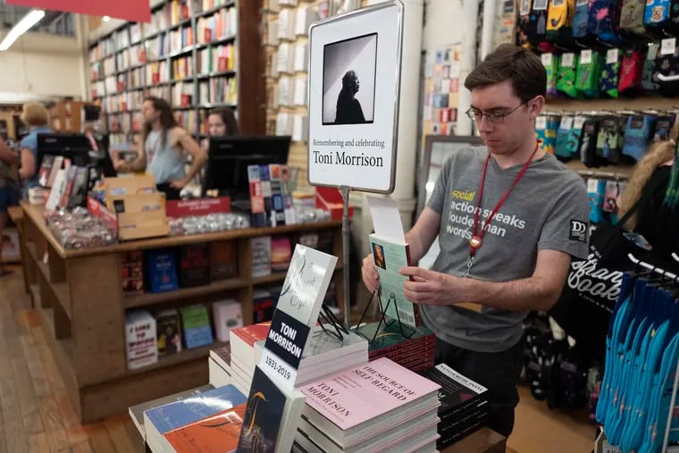 Spencer Robelen, visual merchandiser for the Strand Bookstore, arranging a display of Toni Morrison books on Aug. 6, 2019 in New York. When the owner of the famed book store asked for help on Oct. 23, more than 25,000 orders poured in over a weekend. One woman in the Bronx bought 197 books.