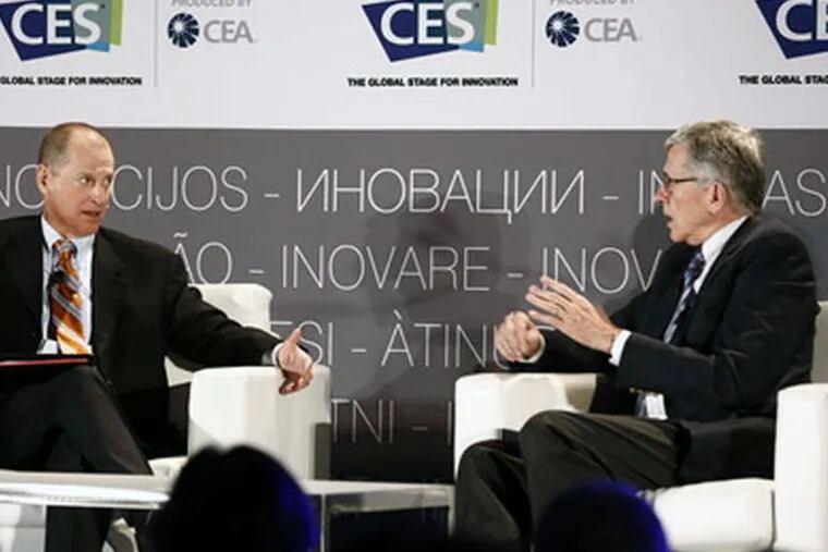 FCC Chairman Tom Wheeler (right) speaks with Gary Shapiro, head of the Consumer Electronics Association, at the Las Vegas electronics show.