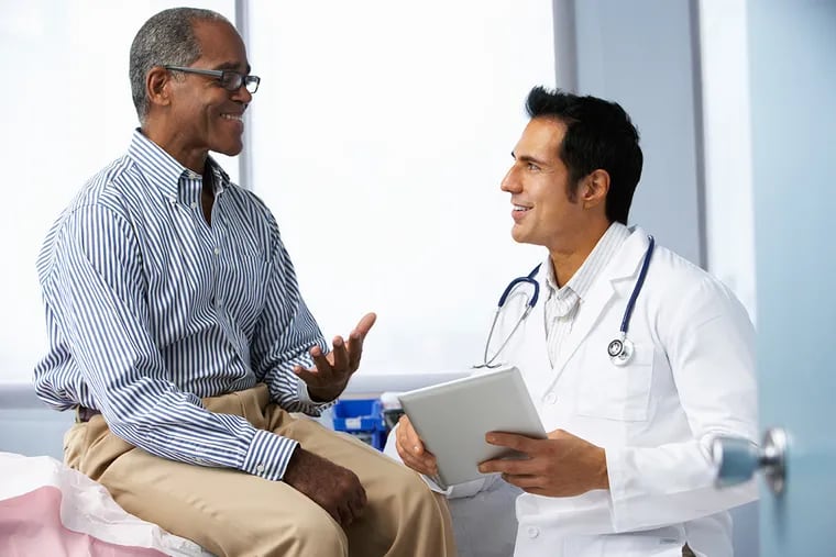 A primary care doctor listens to a patient.