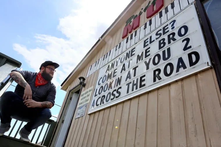 Jim Bohon, a music instructor with Bridge Kaldro Music, touched off the sign war challenging businesses to poke silly fun at one another.