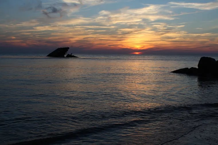 Sunset Beach in Cape May, silhouetting an old cement ship that sunk years ago.  South Jersey has seen the fastest level of sea rise on the East Coast, according to a Rutgers study.