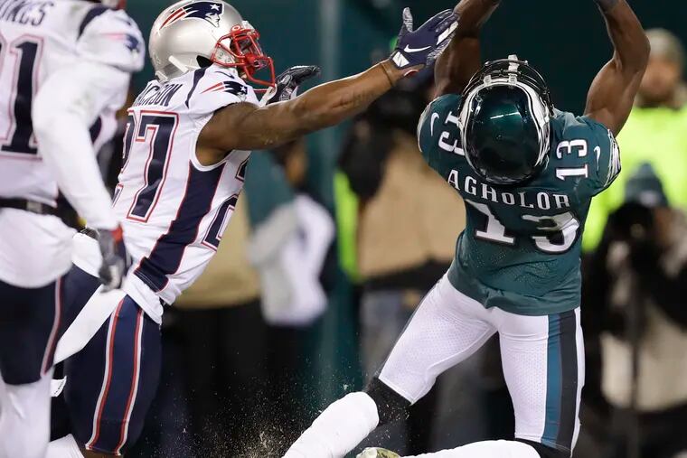 Eagles wide receiver Nelson Agholor attempts to catch the football in the end zone late in the fourth quarter past New England Patriots cornerback J.C. Jackson.