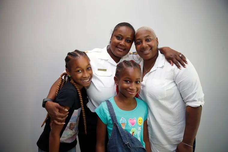 Capt. Jacqueline Bailey-Davis with (from left) Icey Sparks Thomas, Wynter Skye Thomas, and their mother, Tanisha Pratt-Thomas: The captain was a great comfort to the family after the death of young Tyhir Barnes.