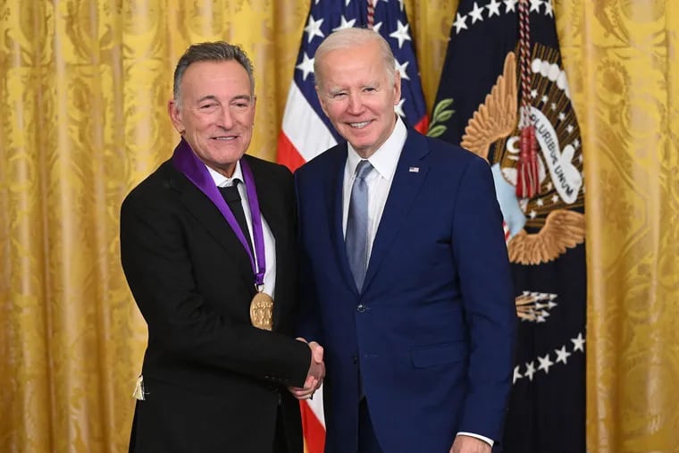President Joe Biden, right, awards musician Bruce Springsteen with the National Medal of Arts.
