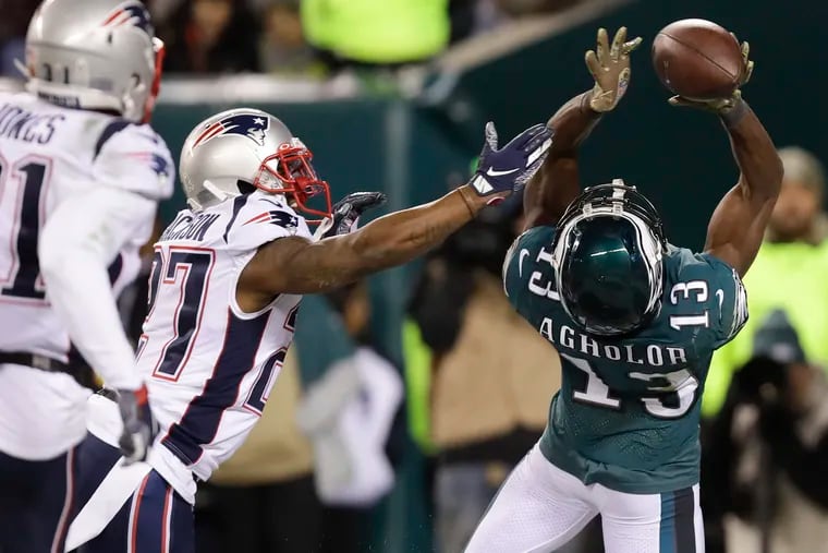 Eagles wide receiver Nelson Agholor attempts to catch the football in the end zone late in the fourth-quarter past New England Patriots cornerback J.C. Jackson on Sunday, November 17, 2019 in Philadelphia.