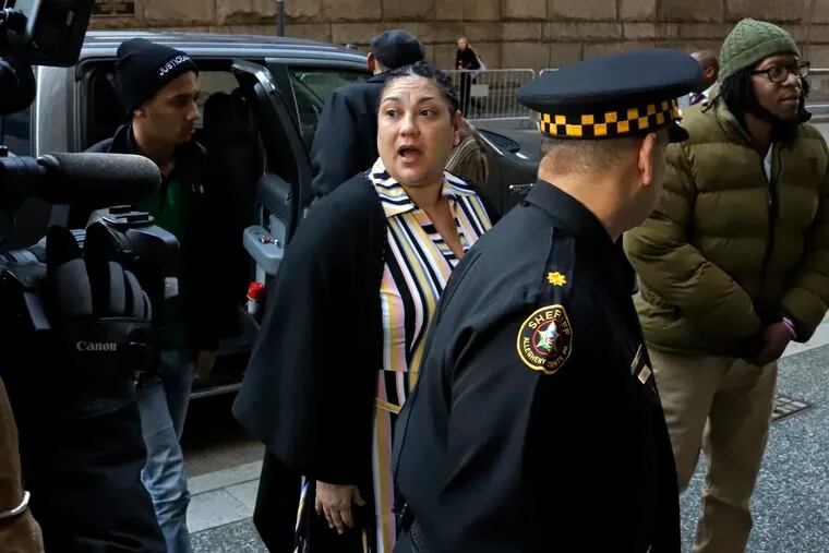 Michelle Kenney, center, the mother of Antwon Rose II, arrives at the Allegheny County Courthouse with supporters on the second day of the trial for Michael Rosfeld, a former police officer in East Pittsburgh, Pa., Wednesday, March 20, 2019.  Rosfeld is charged with homicide in the fatal shooting of Antwon Rose II as he fled during a traffic stop on June 19, 2018.