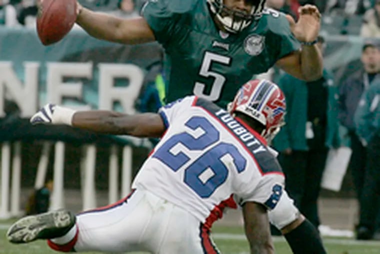 Eagles quarterback Donovan McNabb does some fancy footwork to elude a charging Ashton Youboty of the Bills in the second quarter. McNabb was 29 of 41 passing for 345 yards, a touchdown and an interception in the season finale.