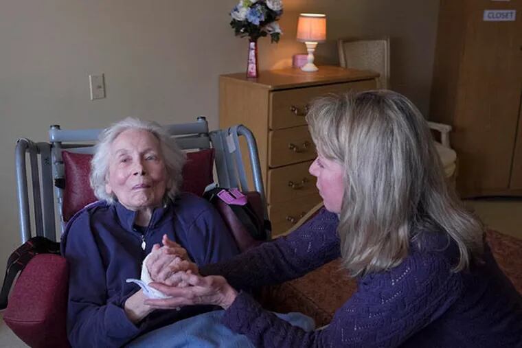 Carol Harrison visits with her mother, Grace Ward, at a Glenside nursing home. Harrison, who has seen other relatives stricken, wants to learn all she can about her options if dementia strikes her. ( ED HILLE / Staff Photographer )