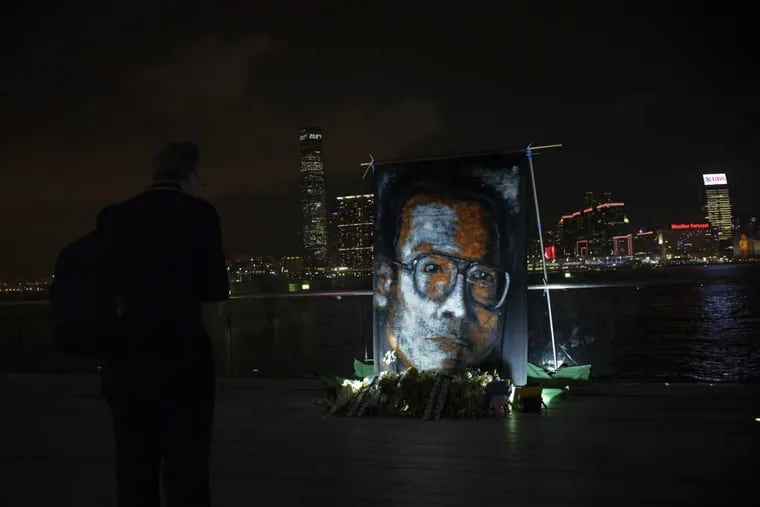 A man pays tribute to late Chinese Nobel Peace laureate Liu Xiaobo at a downtown park along Victoria Harbor in Hong Kong on Wednesday.