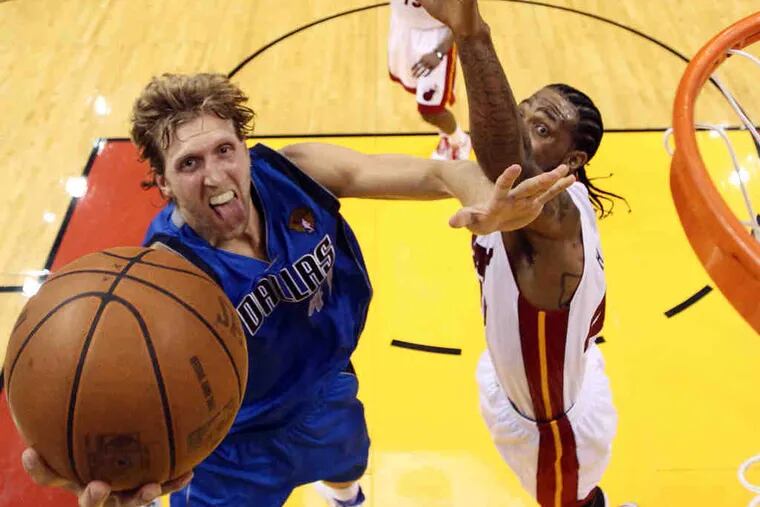 Dallas' Dirk Nowitzki gets to the rim past the outstretched Udonis Haslem of Miami during the first half.