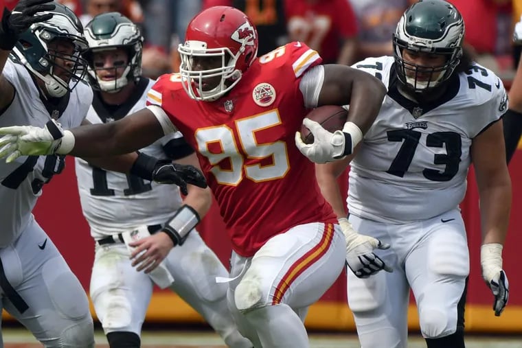 Kansas City Chiefs defensive lineman Chris Jones (95) is flanked by Philadelphia Eagles offensive guard Brandon Brooks (79) and offensive guard Isaac Seumalo (73) catching a deflected pass from Philadelphia Eagles quarterback Carson Wentz for a turnover, during the second half of an NFL football game in Kansas City, Mo., Sunday, Sept. 17, 2017. (AP Photo/Ed Zurga)