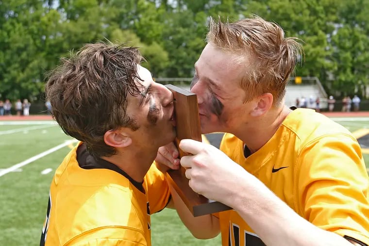 Moorestown teammates (from left) Chris Furze and Patrick Coleman kiss the trophy after the Quakers won the South Jersey Group 3 lacrosse championship by defeating Shawnee.