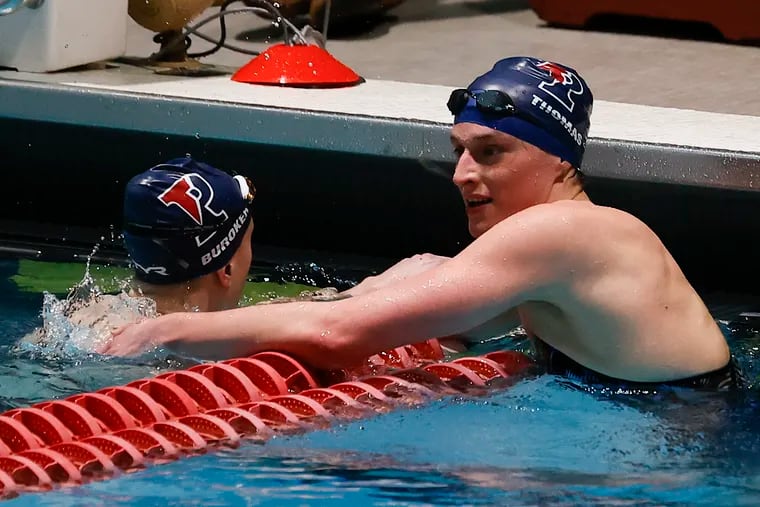 Penn's Lia Thomas (right) celebrates  with teammate Catherine Buroker after they placed first and second in the women's 500 freestyle final at the Ivy League championships at Harvard University