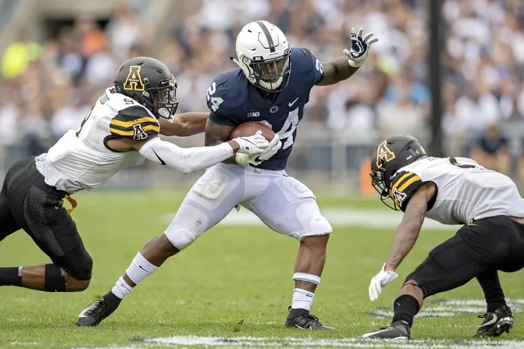 Penn State running back Miles Sanders avoids a tackle from Appalachian State defensive back Austin Exford during Saturday's game at Beaver Stadium.
