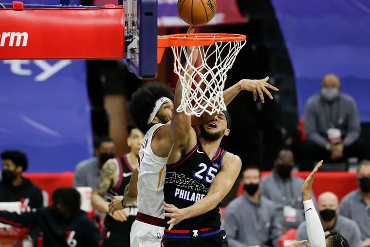 Sixers guard Ben Simmons gets hit by the Cavaliers' Jarrett Allen driving for a layip during the first quarter.