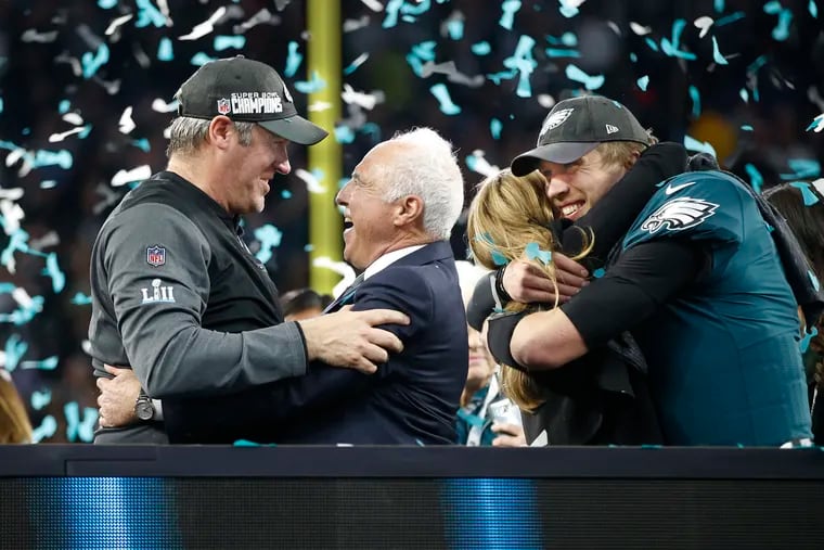 Coach Doug Pederson and Eagles owner Jeffrey Lurie rejoice as they wait with backup-turned-starter Nick Foles to receive the Lombardi Trophy after Super Bowl LII. Lurie and Pederson drafted Jalen Hurts in the second round Friday to do Foles' old job.