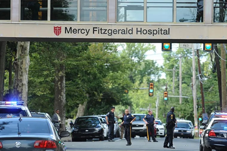 Police block Lansdowne Ave at Fitzgerald Mercy Hospital in Darby after a shooting July 24, 2014 in the Wellness Center. ( CLEM MURRAY / Staff Photographer )