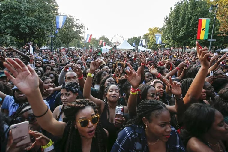 Fans wave their arms while Maleek Berry performed at the Tidal Stage during Made In America along the Benjamin Franklin Parkway on Sunday, September 3, 2017.