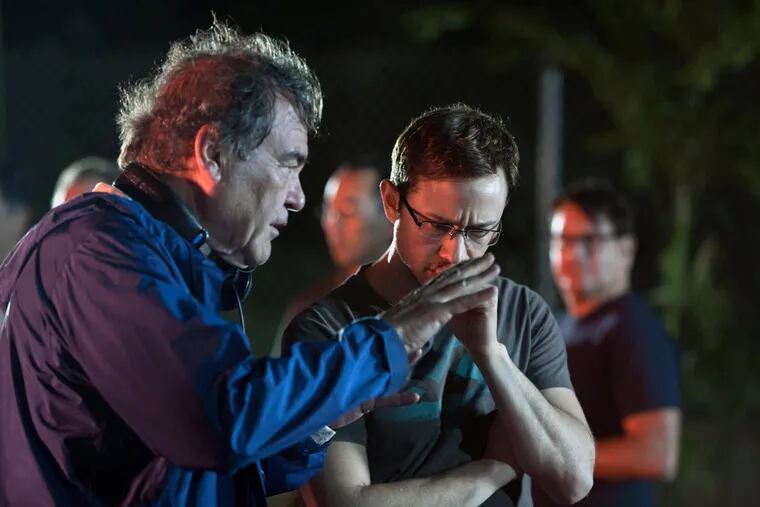 Director Oliver Stone speaks with Joseph Gordon-Levitt on the set of "Snowden."