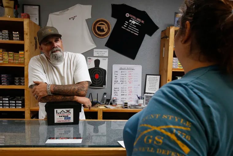 In this photo taken Tuesday, June 11, 2019, Chris Puehse, left owner of Foothill Ammo helps a customer at his shop in Shingle Springs, Calif. Californians will have to undergo criminal background checks every time they buy ammunition starting July 1 under a 2016 voter-approved ballot initiative. (AP Photo/Rich Pedroncelli)