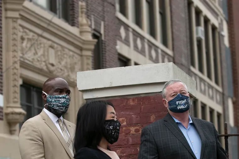 Mayor Jim Kenney, Councilmember Helen Gym and Councilmember Derek Green stand outside of Lowell Elementary in the Olney section of Philadelphia during a news conference and demanded more funding for schools floundering under the pressure of the coronavirus pandemic. Wednesday is the first day of virtual school for 125,000 Philadelphia School District students.