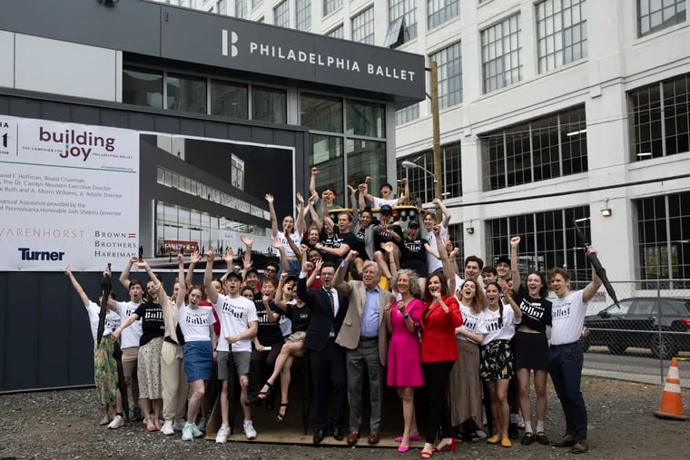 Company dancers and others pose for a photo on construction equipment at the future site of the Philadelphia Ballet at North Broad and Wood Streets in Philadelphia on Thursday, May 23, 2024. Construction is expected to begin soon for the multi-million dollar project.