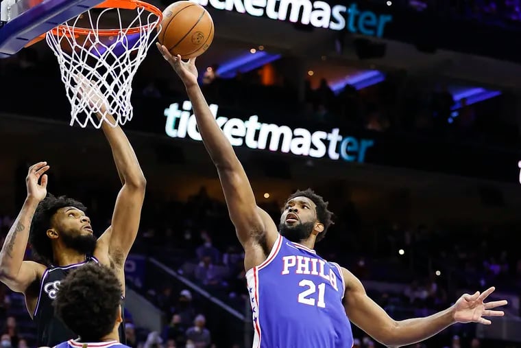 Sixers center Joel Embiid attempts to lay-up the basketball against Sacramento Kings forward Marvin Bagley III during the first quarter on Saturday, January 29, 2022 in Philadelphia.