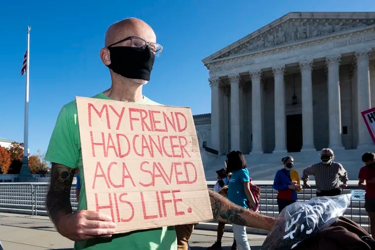 A man with a sign saying "My friend had cancer ACA saved his life" at a demonstration in front of the U.S. Supreme Court in Washington, D.C., in favor of the Affordable Care Act on Nov. 10, 2020, the day the Supreme Court heard arguments in a case that Texas and other states brought to remove the Affordable Care Act. (Michael Brochstein/ZUMA Wire/TNS)