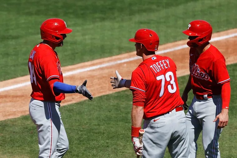 The Phillies' Jake Cave (left) celebrates his two-run home run in the second inning with teammates Will Toffey (center) and Scott Kingery on Wednesday.