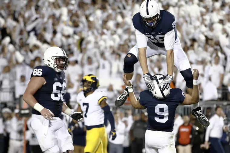 Penn State's Mike Gesicki (88) celebrates by jumping over his quarterback Trace McSorley  after McSorley, scored a touchdown against Michigan.