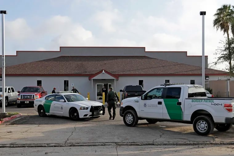 FILE - In this June 23, 2018, file photo, a U.S. Border Patrol Agent walks between vehicles outside the Central Processing Center in McAllen, Texas. U.S. border agents have temporarily closed their primary facility for processing migrants in South Texas one day after authorities say a 16-year-old died after being diagnosed with the flu at the facility. In a statement released late Tuesday, May 21, 2019, U.S. Customs and Border Protection said it would stop detaining migrants at the processing center in McAllen, Texas. CBP says "a large number" of people in custody were found Tuesday to have high fevers.