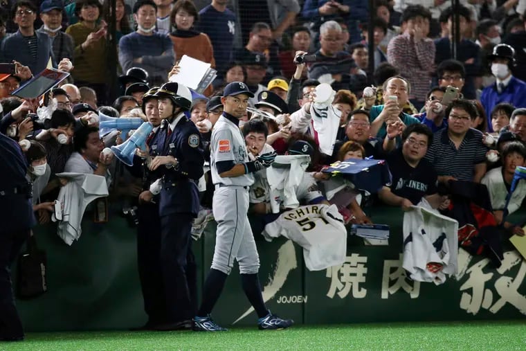 Seattle Mariners right fielder Ichiro Suzuki gives his autographs to fans prior to Game 2 of the Major League baseball opening series against the Oakland Athletics at Tokyo Dome in Tokyo, Thursday, March 21, 2019. (AP Photo/