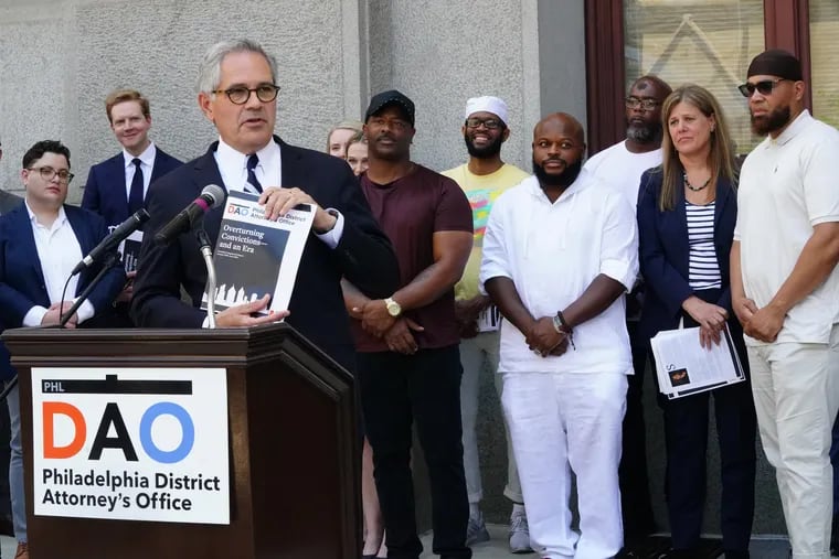 DA Larry Krasner, front left, shown here at a press conference with a report detailing the work of the Conviction Integrity Unit from January 2018 to June 2021, behind him (Left to Right starting with back center) Chester Hollman III, Theophalis Wilson, Jimmy Dennis, Christopher Williams, Patricia Cummings, Supervisor, Conviction Integrity Unit, and Terrance Lewis, at City Hall in Philadelphia, June 15, 2021.