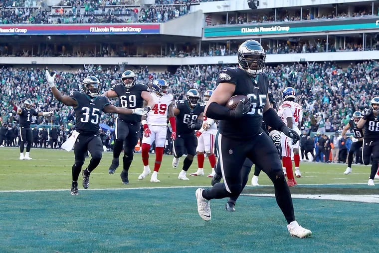 Philadelphia Eagles offensive tackle Lane Johnson (right) scores a touchdown in the fourth quarter as the Philadelphia Eagles play the New York Giants at Lincoln Financial Field in Philadelphia, Pa. on Sunday, Dec. 26, 2021.