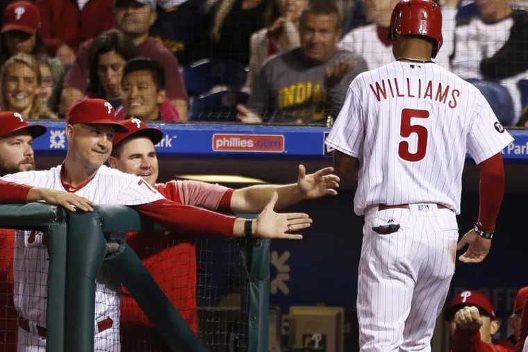 Phillies outfielder Nick Williams (right) is congratulated after scoring on a balk.