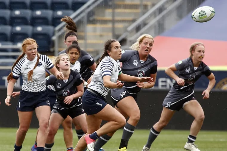 Players from Penn State (in white) and Bloomsburg eye the ball during pool play of the Collegiate Rugby Championship tournament Saturday, June 3, 2017 at Talen Energy Stadium in Chester. Penn State went on to win, 39-0. LOU RABITO / Staff