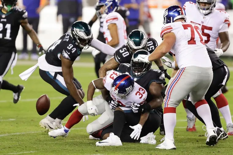 Giants running back Dion Lewis fumbles the ball against Eagles defensive tackle Fletcher Cox in the second quarter.