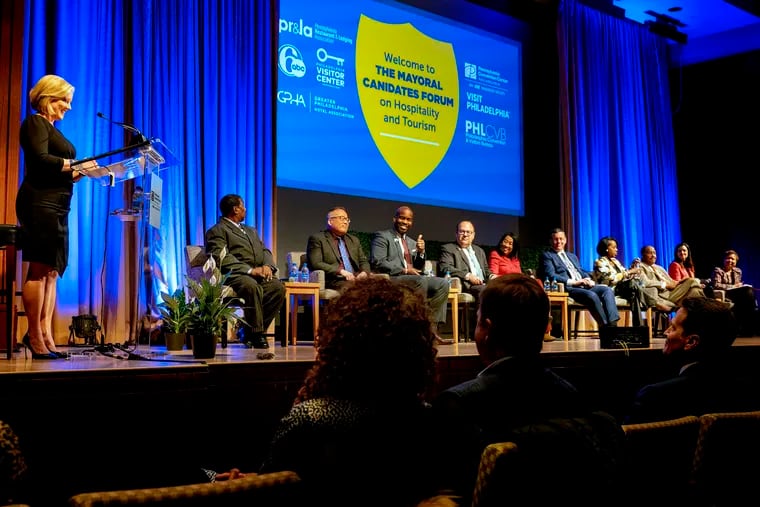 Candidates for mayor: (seated, from left) Warren Bloom Sr., David Oh, Derek Green, Allan Domb, Helen Gym, Jeff Brown, Cherelle Parker, James DeLeon, Rebecca Rhynhart, and Maria Quiñones-Sánchez during a mayoral forum at the Convention Center Tuesday. Television journalist Sarah Bloomquist, of 6ABC, (left) moderated the event.