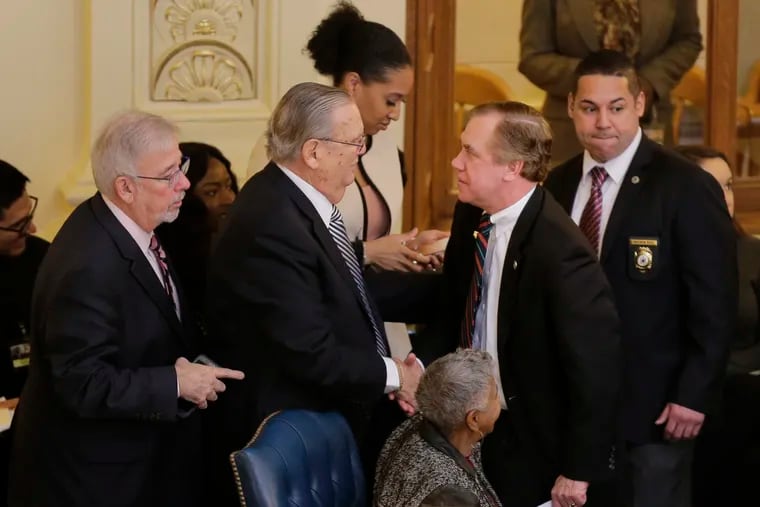 Assembly Speaker Craig Coughlin, second from right, is greeted by colleagues after a vote to raise the minimum wage in Trenton, N.J., Thursday, Jan. 31, 2019. New Jersey lawmakers are set to vote on legislation phasing in over five years an hourly minimum wage of $15. (AP Photo/Seth Wenig)