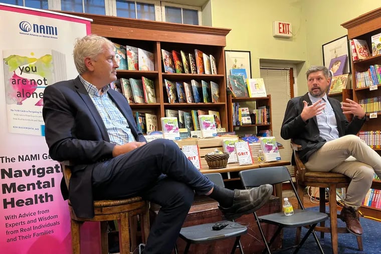 Ken Duckworth (left) the chief medical officer of the National Alliance on Mental Illness and author of the new book You Are Not Alone, talking with Nick Emeigh (right), who shared his journey with mental illness in the book.
