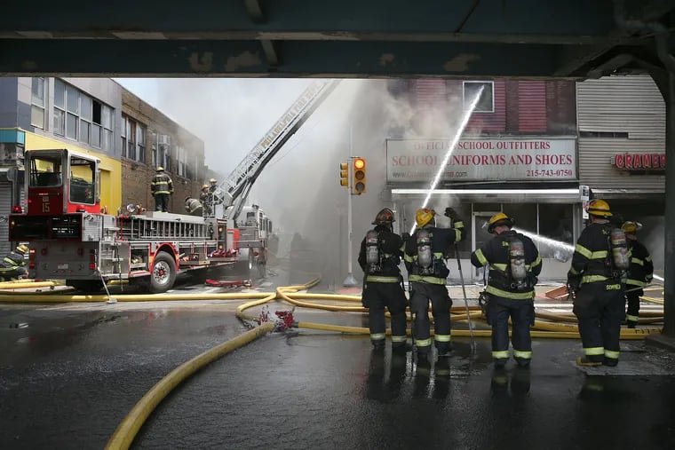Philadelphia Fire Department firefighters battle a multi-alarm fire in the 4500 block of Frankford Avenue.