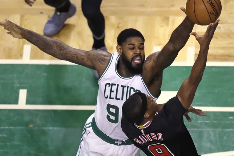 Boston Celtics forward Amir Johnson (90) blocks a shot by Chicago Bulls guard Rajon Rondo (9) during the first quarter of a first-round NBA playoff basketball game in Boston, Tuesday, April 18, 2017. (AP Photo/Charles Krupa)