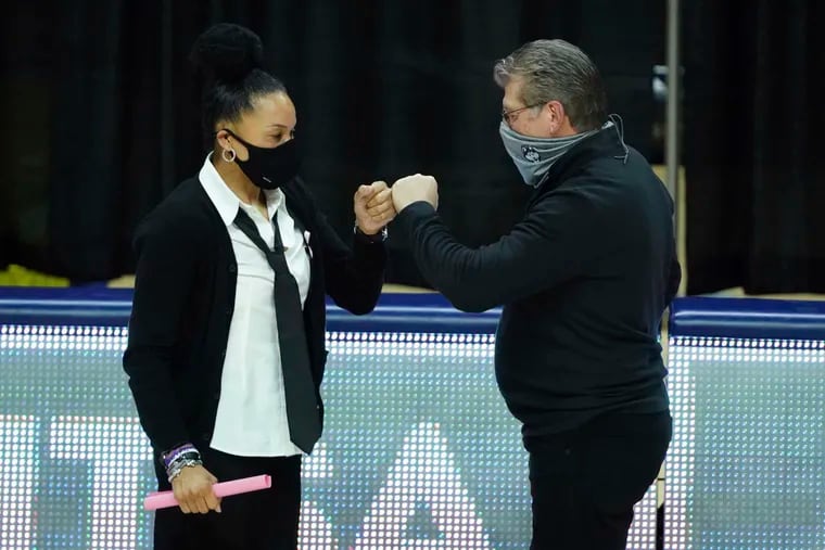 Dawn Staley (left) and Geno Auriemma (right) at the South Carolina-Connecticut game in Storrs, Conn., on Feb. 8, 2021. The game took place soon after the death of John Chaney, and Staley paid tribute with her Chaney-style outfit.