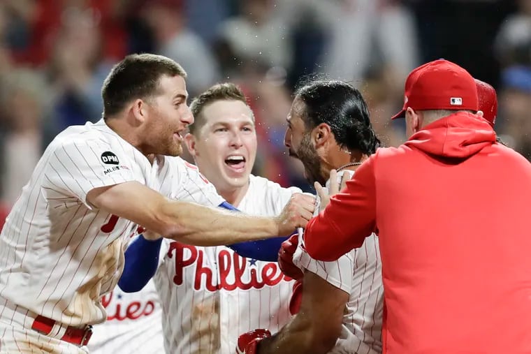 Sean Rodriguez celebrates with his teammates after hitting a walk-off home run in the 11th to give the Phillies a 6-5 win over the Pirates Monday night.